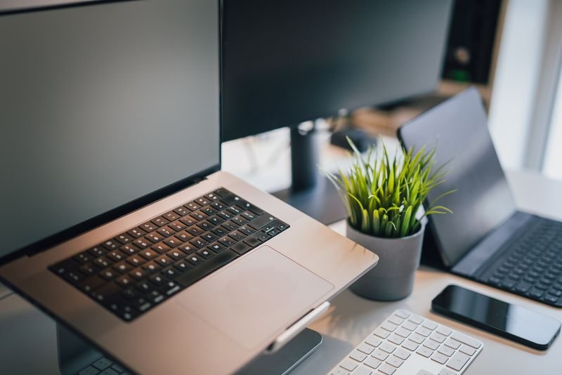 Laptop and monitors on a bright desk