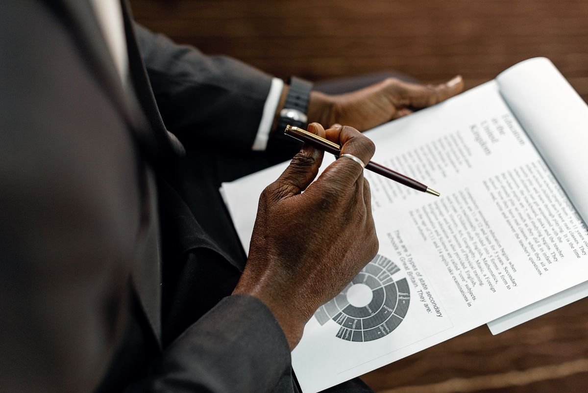 Person reviewing a printed document with a pen